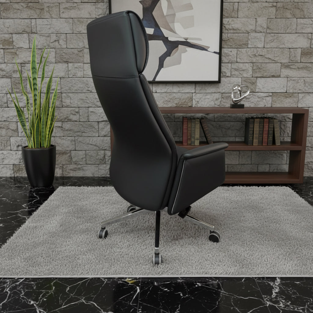 Black leather executive office chair with chrome base positioned backside in a modern workspace — luxury ergonomic seating for premium offices by DreamSpace Collection Ontario.
